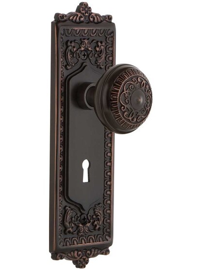 Egg and Dart Design Mortise Lock Set With Matching Knobs in Timeless Bronze.